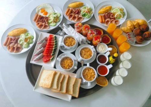 a plate of food on a table with plates of food at Krabi Tipa Resort in Ao Nang Beach