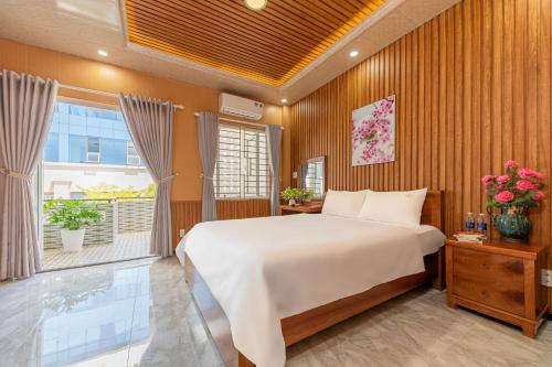 a bedroom with a large bed and a window at Green House in Danang