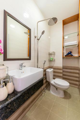 a bathroom with a sink and a toilet at Green House in Danang
