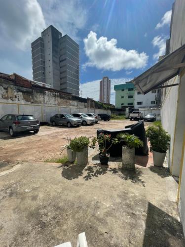 a parking lot with potted plants and buildings at Pousada Iracema Centro in Fortaleza