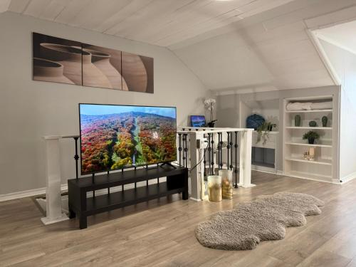 a living room with a flat screen tv on a wall at Family-Friendly 3BR in Little Italy in Toronto