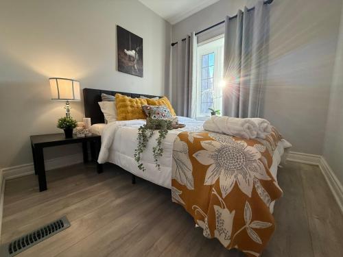 a bedroom with a bed and a window at Family-Friendly 3BR in Little Italy in Toronto