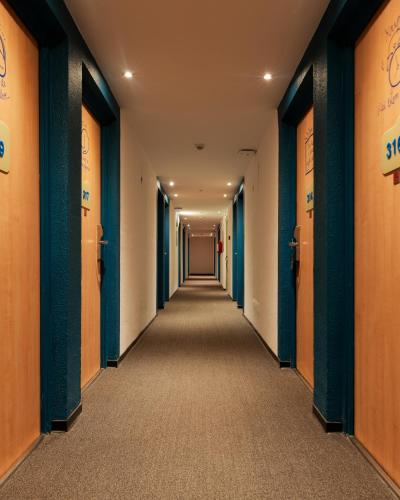a corridor of an office with orange and blue walls at MIA Urban Fès in Fès