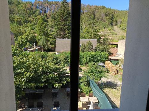a view from a window of a yard with trees at Route 999 in Alzon