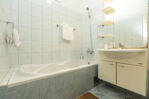 a white bathroom with a tub and a sink at Boki 2 one bedroom apartment in old town with balcony in Zadar