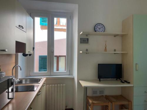 a kitchen with a sink and a window and a tv at Roncati 7 center town studio apartments in Bellagio