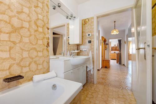 a bathroom with a white tub and a sink at La casa delle Fate in Roncone