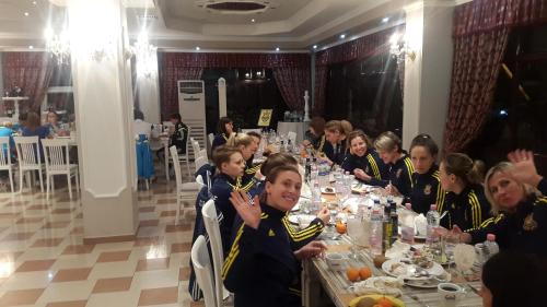 a group of women sitting at a table in a restaurant at Univers Resort in Elbasan