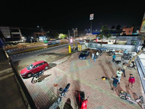 a red car parked at a gas station at night at SAlBALA LODGE - AC ROOMS WITH COOKING FACILITIES Near CMC in Vellore