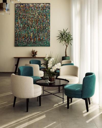 a room with chairs and a table and a painting at MIA Urban Detroit Tanger in Tangier