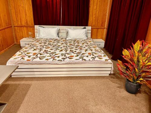 a large bed in a bedroom with red curtains at Kashmiri kothi - Srinagar stay in Srinagar
