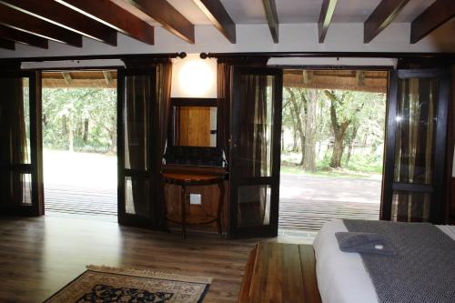 a room with a bed and sliding glass doors at House On Blyde in Kampersrus AH