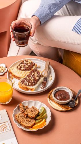 a person sitting on a table with a plate of food at ibis Styles Montauban in Montauban