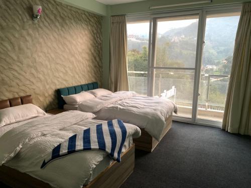 Postel nebo postele na pokoji v ubytování Hotel Shivaya