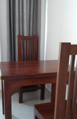 a wooden table and two chairs with a wooden table and a wooden table at Mirissa Cocoon in Mirissa