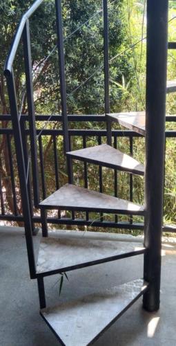 a bench sitting on top of a porch at Mirissa Cocoon in Mirissa