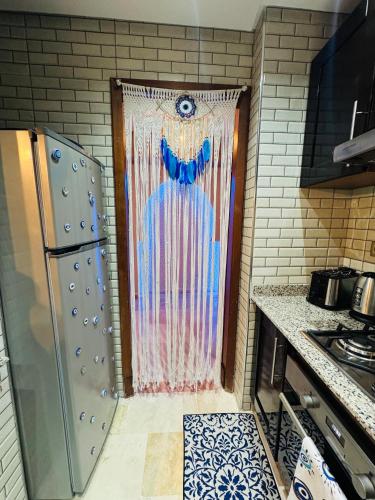 a door in a kitchen with a painting on it at Riad le marin Coucou beach in Agadir