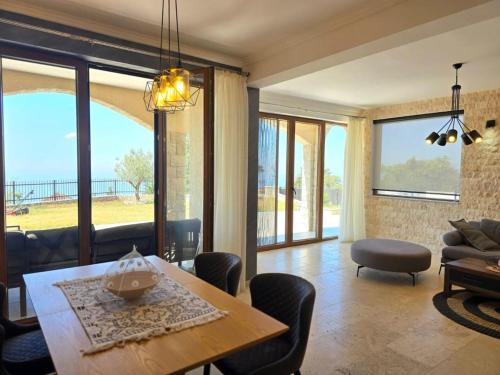 a living room with a table and chairs and a couch at Villa Trend, Budva, Kuljače in Budva