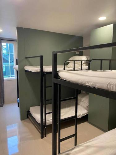 a room with three bunk beds in a room at Hood Pattaya in Pattaya