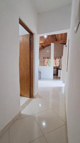 a room with a door and a white floor at Casa espaçosa e acolhedora SFX in São Francisco Xavier