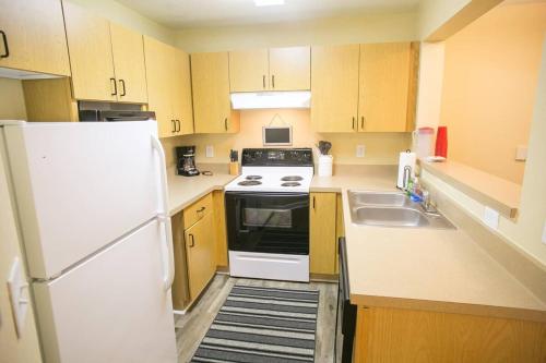 a small kitchen with a white refrigerator and a sink at Athens in Style! in Athens