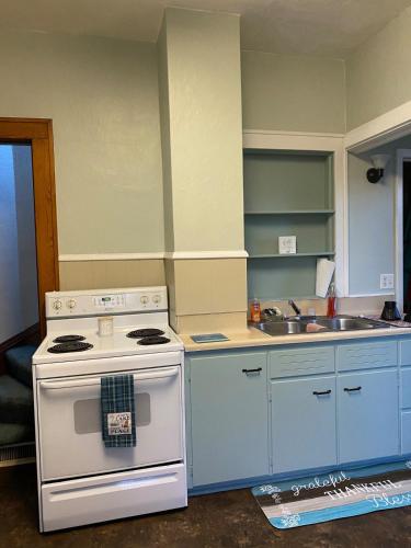 a kitchen with a white stove and a sink at Getaway with a small town feel in Currie