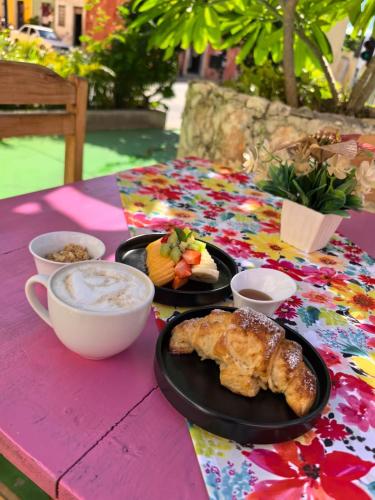 a table with two plates of food and a cup of coffee at Hotel Don Luis in Valladolid