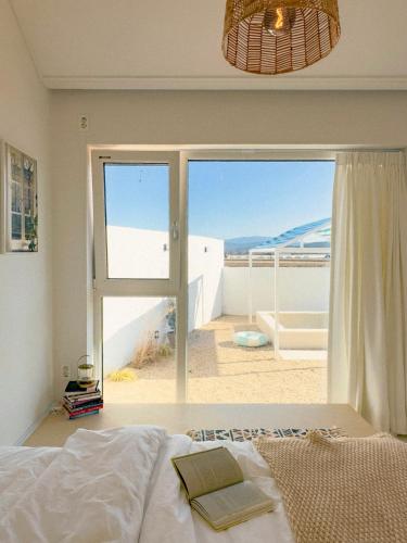 a bedroom with a bed and a view of the beach at Byeolsai in Gyeongju