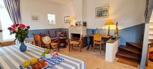 un salon avec une table et une cheminée dans l'établissement Charmante Maison de village avec étage, à La Couarde-sur-Mer