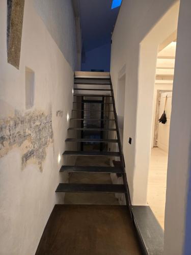 a staircase in a room with white walls and wooden floors at Untere Vorstadt, Deggendorf in Deggendorf
