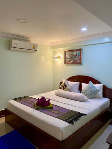 a small bedroom with a bed with avisor at Chan Sothea Guest House in Battambang