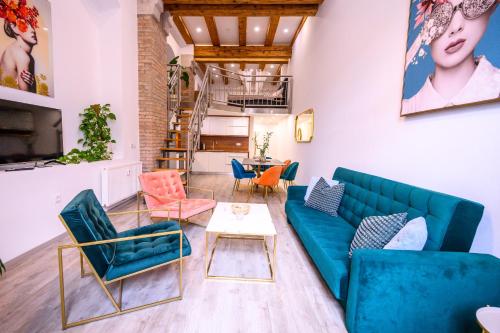 a living room with a blue couch and chairs at The LOFT Ljubljana in Ljubljana