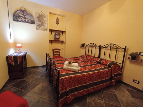 a bedroom with a bed with a teddy bear on it at La Villa del Conte in Scicli