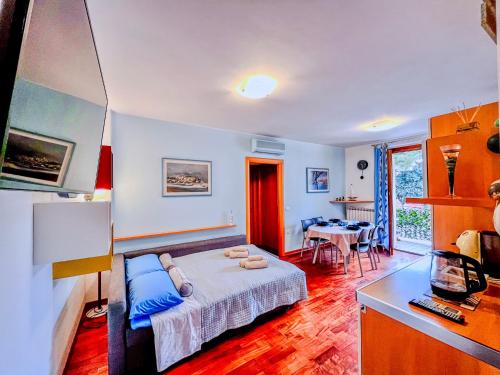 a bedroom with a bed and a kitchen with a table at Tra Onde & Vicoli - Parcheggio PRIVATO in Porto Recanati