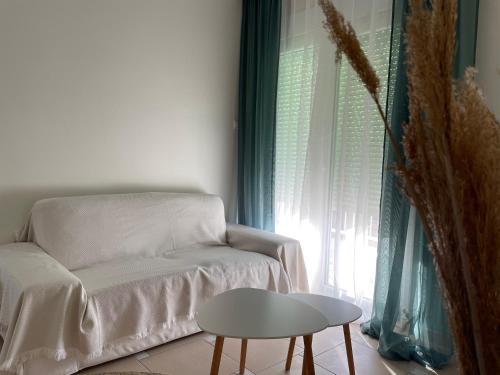 a living room with a couch and a table and a window at Mimis place in Fanárion