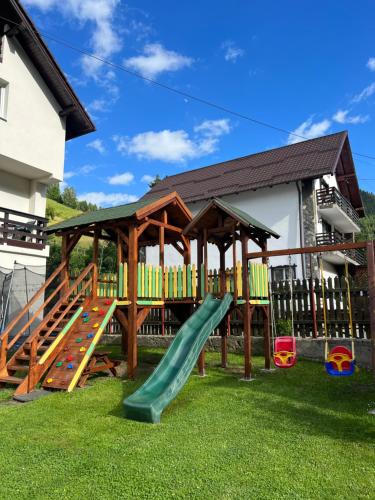 a playground with a slide and a gazebo at Casa Mia in Moieciu de Sus