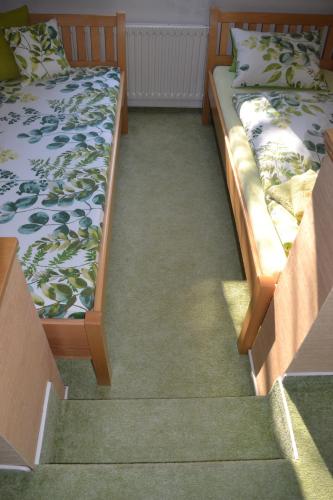 two beds sitting next to each other in a room at Pension U akátu in Prague