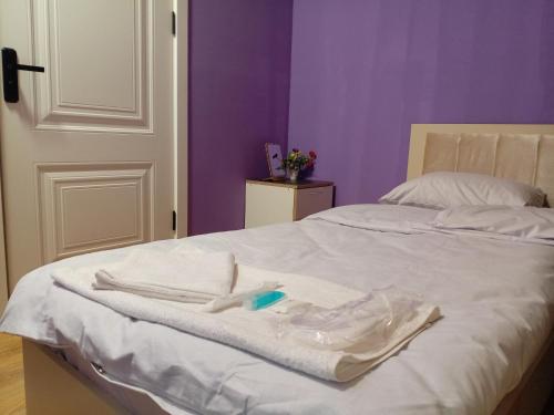 a bed with a robe and a toothbrush on it at Baku Express Hostel in Baku