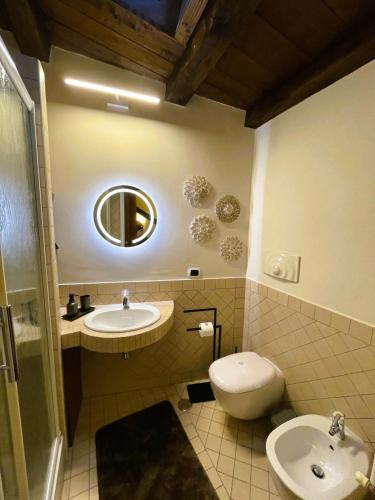 a bathroom with a sink and a toilet and a mirror at Domus Telesio Bed & Breakfast in Cosenza
