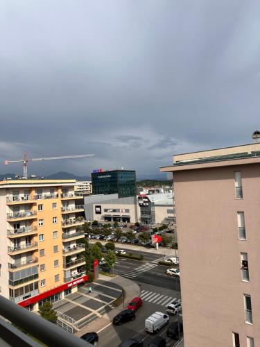 a view of a city with a parking lot and buildings at Apartman Natalia in Podgorica