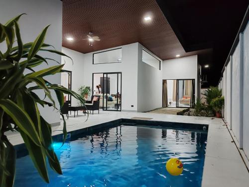 a house with a swimming pool in the middle of a yard at Casa Pacifica in Uvita