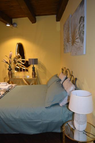 a bedroom with a bed and a table with a lamp at Domus Telesio Bed & Breakfast in Cosenza