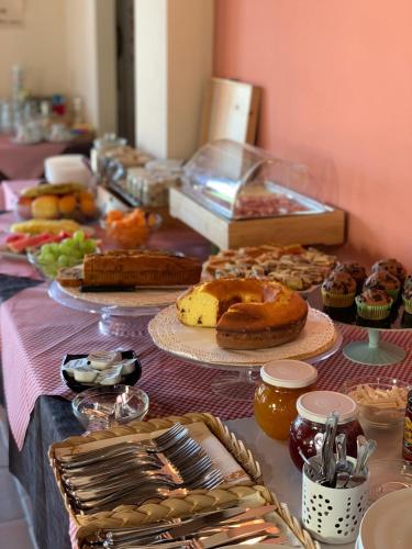 a table filled with different types of pastries on plates at Collina dei Poeti in Santarcangelo di Romagna