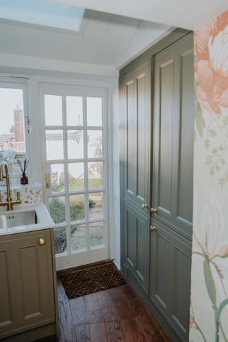 a kitchen with a sink and a window at Rose & Star Cottage in Frome