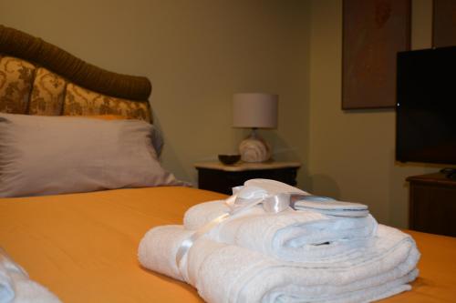 a pile of towels sitting on top of a bed at Domus Telesio Bed & Breakfast in Cosenza