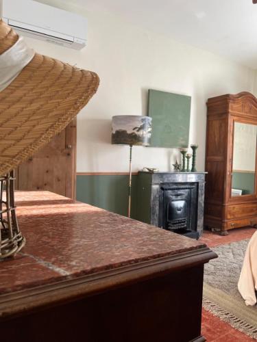 - une chambre avec un lit et un poêle à bois dans l'établissement Maison BIS, à Roujan