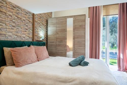 a bedroom with a large bed with a brick wall at Tzànnou farm residence in Mytilene