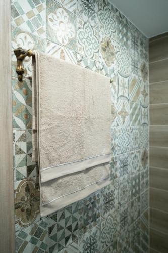 a tiled bathroom with a window and towels at Tzànnou farm residence in Mytilene