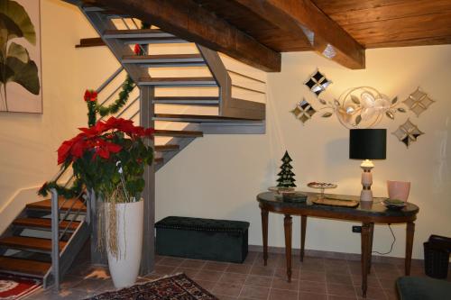 a living room with a spiral staircase and a table at Domus Telesio Bed & Breakfast in Cosenza