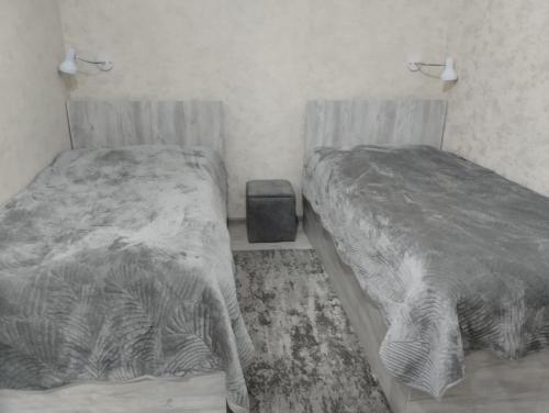 a bedroom with two beds and a trash can at Guest house number 1 in Batumi